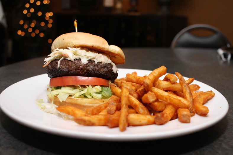 Nikos Frazier | The Youngstown Vindicator Black 'N Cole Burger, a half pound burger with cajun spices and house-made coleslaw from Davidson's Restaurant in Canfield.