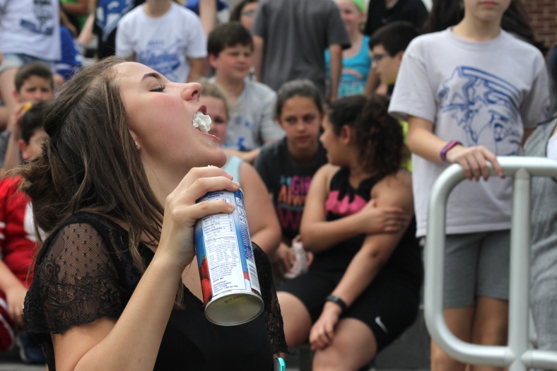Nikos Frazier | The  Vindicator Theresa Detoro, 13, finishes off a bottle of whipped cream after helping out McKinley Elementary School teachers get pied by their students on Friday, June 3, 2016.