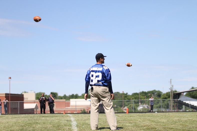 Nikos Frazier | The Vindicator Jim Harbaugh, University of Michigan Football Head Coach, watches as footballs fly though the air during the Warren Harding Elite Camp.