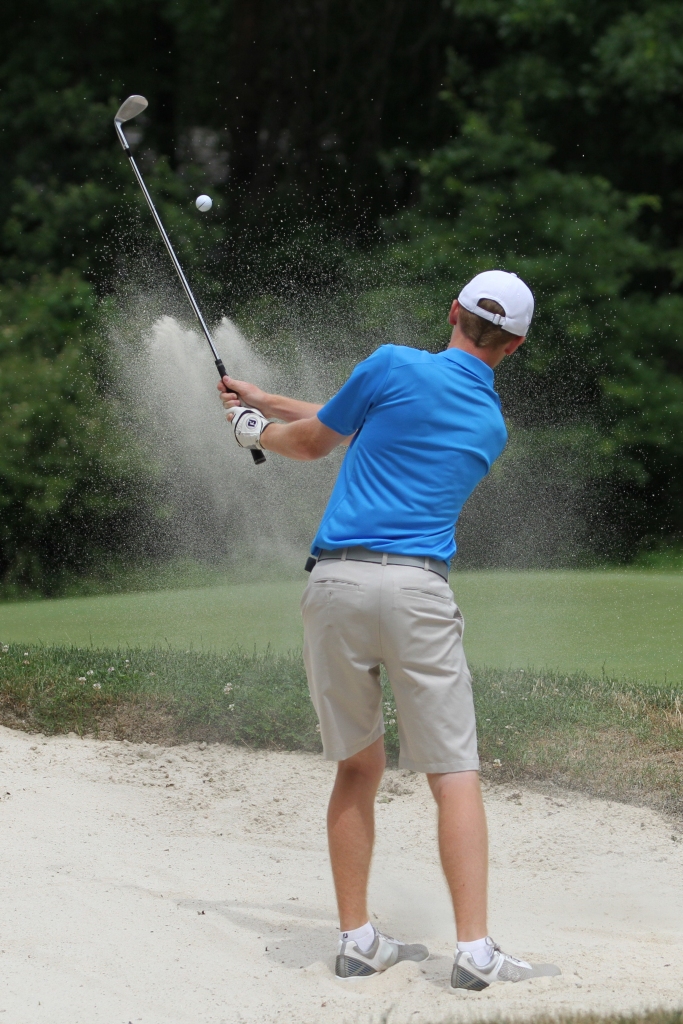 Nikos Frazier | The Vindicator Keegan Butler, of Canfield, chips the ball out of a sand trap on hole 3.